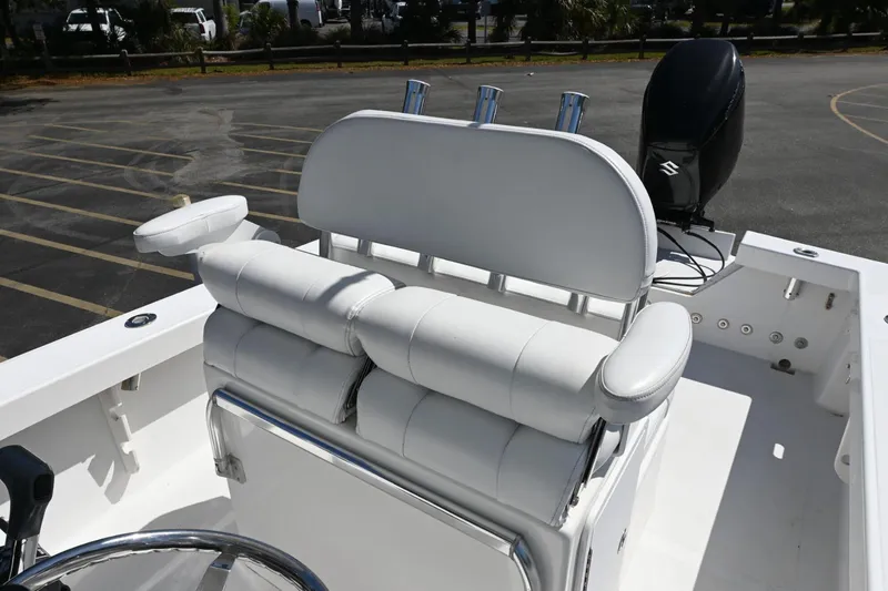 Slide: The Image of White seating on a 2017 Rambo 27 boat with Suzuki outboard motor. - 11