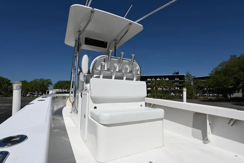 Slide: The Image of 2017 Rambo 27 boat with seating and rod holders under clear blue sky. - 12