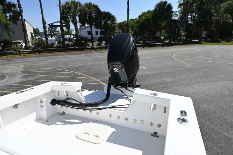 Slide: The Image of Rambo 27 boat, 2017 model, with outboard motor in a parking lot. - 13