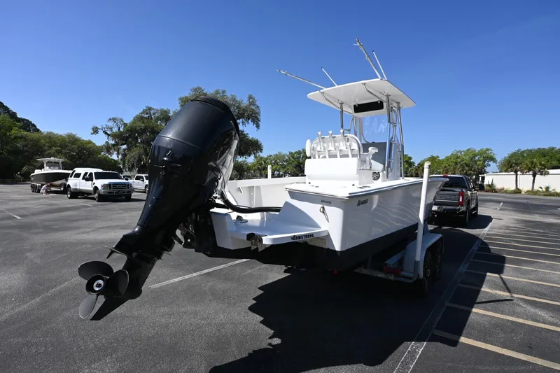 Slide: The Image of 2017 Rambo 27 boat on trailer in parking lot, clear sky background. - 18