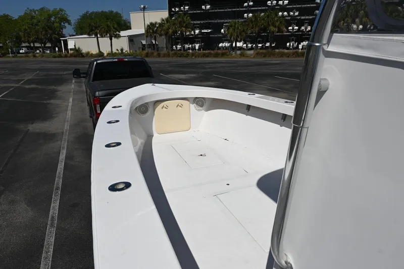 Slide: The Image of 2017 Rambo 27 boat on trailer in parking lot, near black truck. - 3