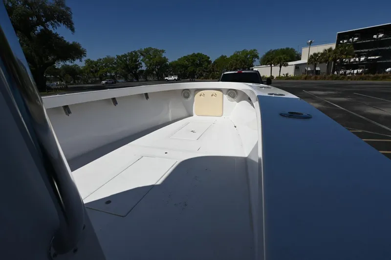 Slide: The Image of 2017 Rambo 27 boat interior, spacious deck, parked outdoors under clear blue sky. - 4