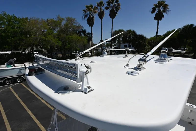 Slide: The Image of Rambo 27 boat roof with antennas and light bar, 2017 model, palm trees in background. - 6