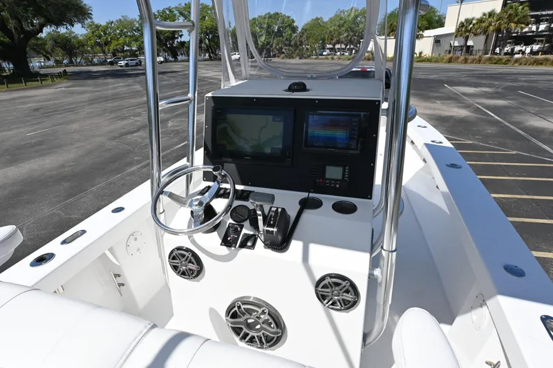 Slide: The Image of Cockpit of 2017 Rambo 27 boat with steering wheel and navigation screens. - 8