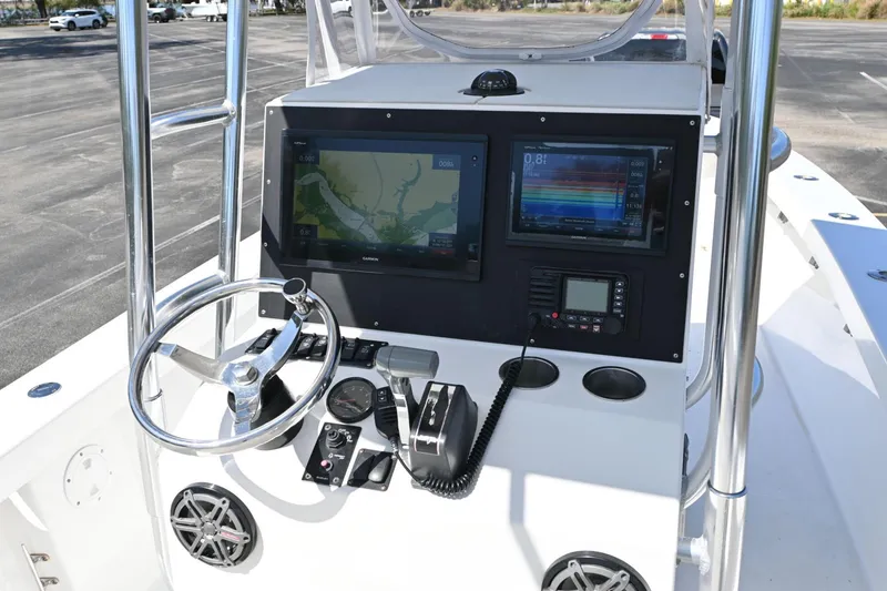 Slide: The Image of Control panel of a 2017 Rambo 27 boat with navigation screens and steering wheel. - 9