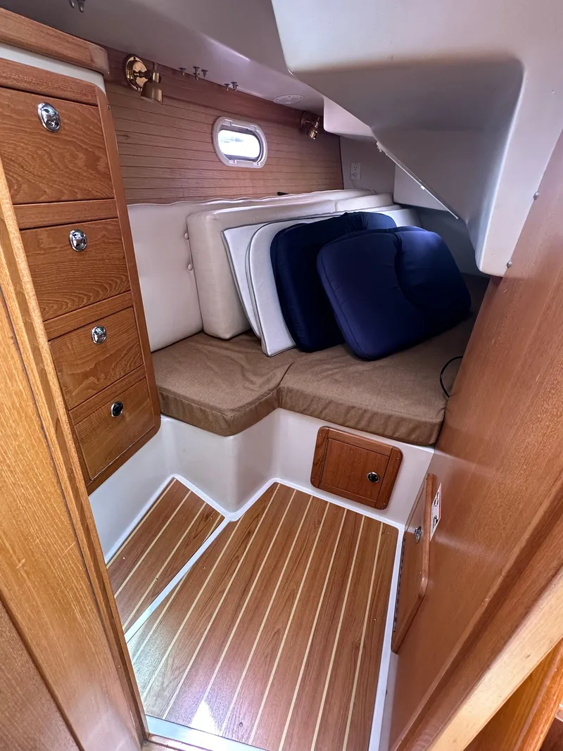 Slide: The Image of Interior cabin of a 2007 Catalina 36 MkII sailboat with wooden flooring and storage. - 17