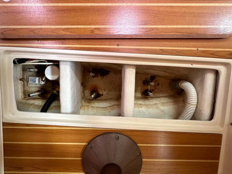 Slide: The Image of Catalina 36 MkII 2007 boat interior compartment with wooden paneling and visible plumbing. - 45