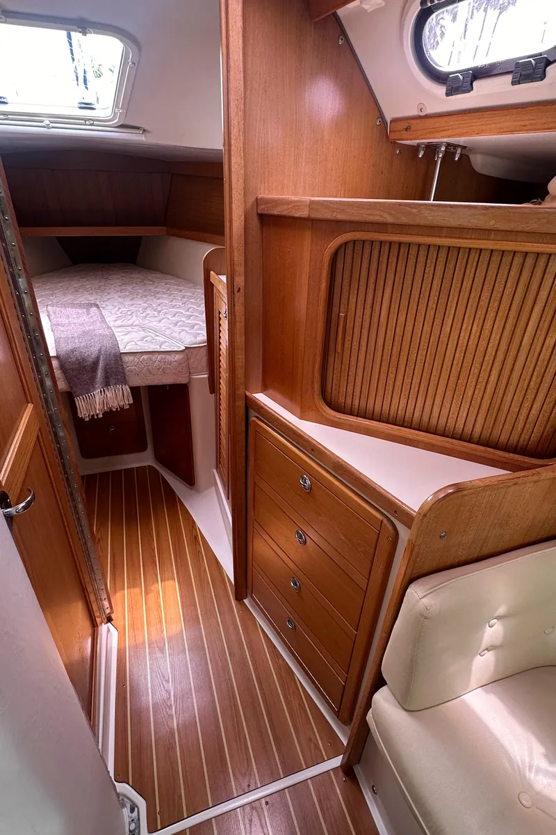 Slide: The Image of Interior cabin of a 2007 Catalina 36 MkII sailboat with wood finish and cozy bed. - 18