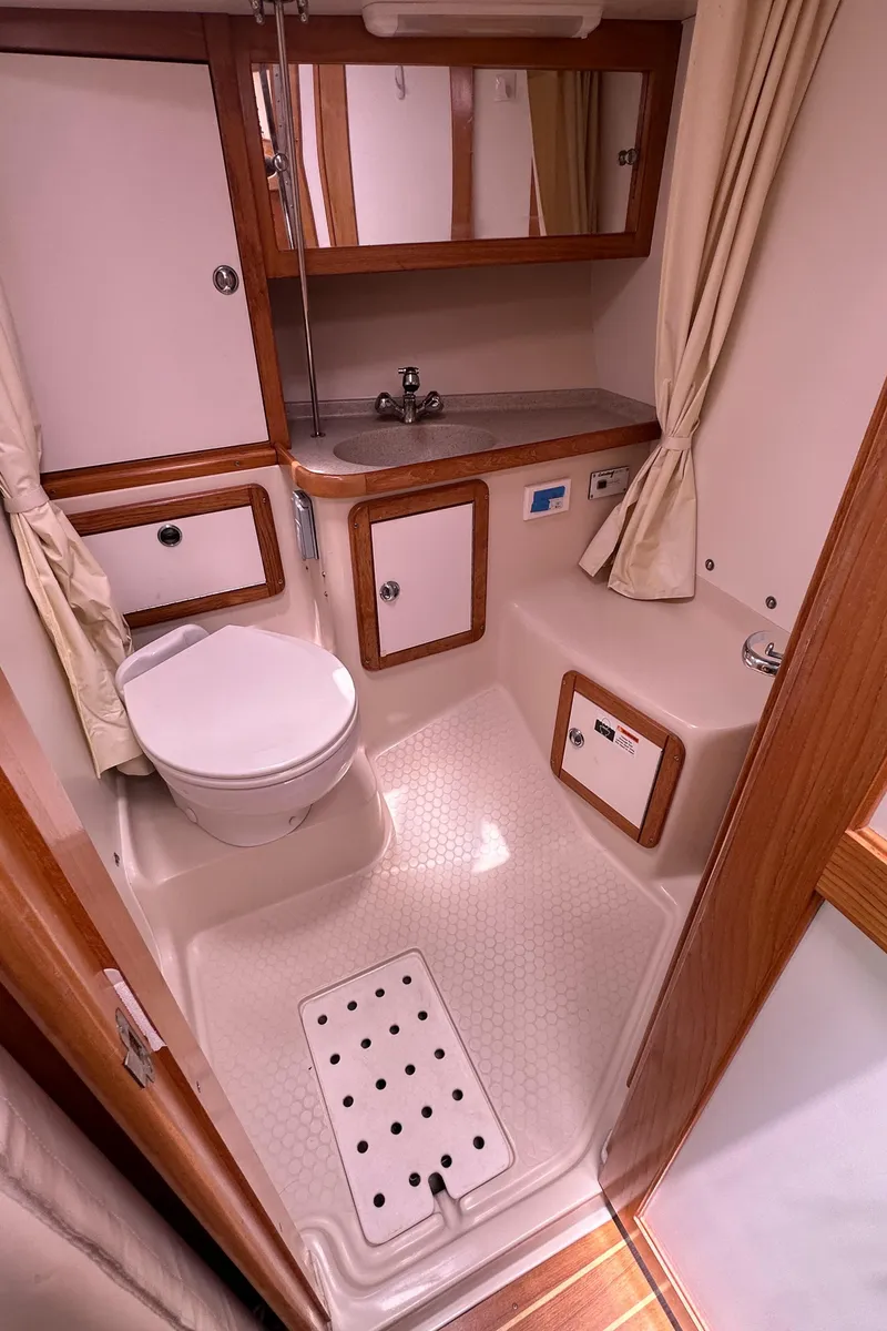 Slide: The Image of 2007 Catalina 36 MkII sailboat bathroom with sink, toilet, and storage cabinets. - 19