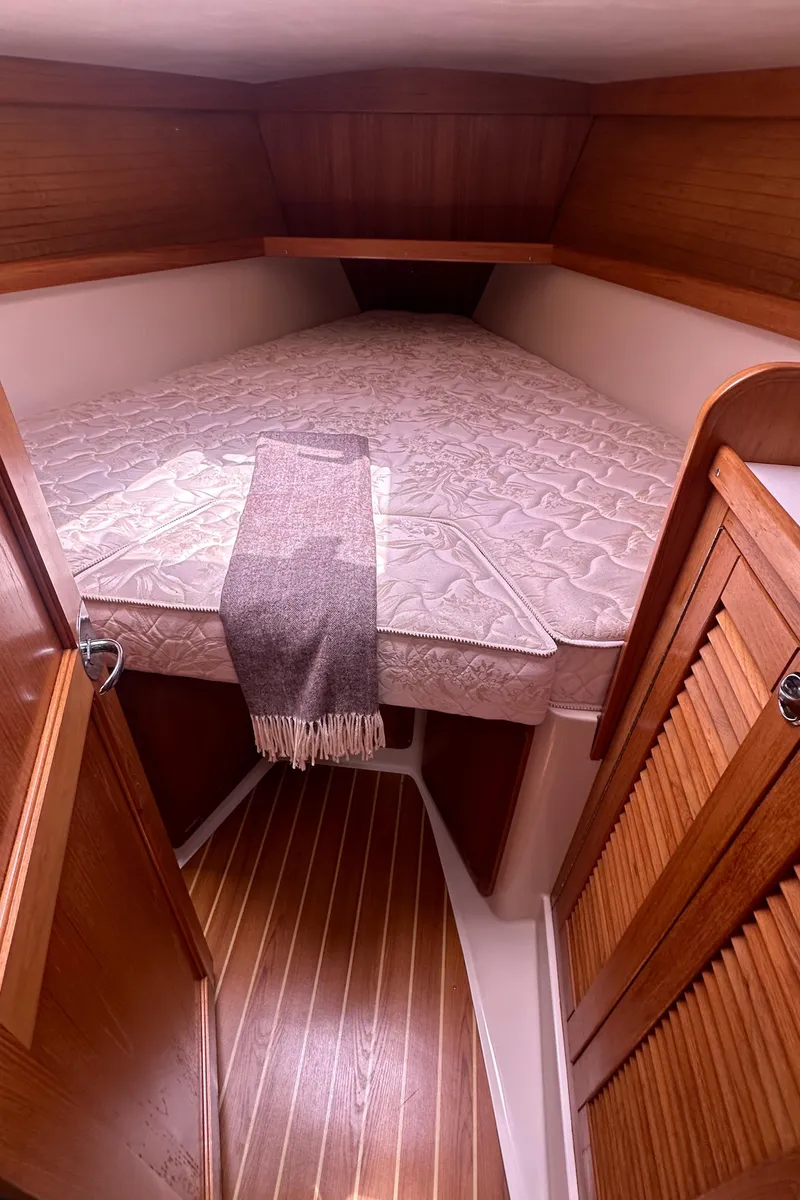 Slide: The Image of 2007 Catalina 36 MkII cozy cabin with bed and wooden interior. - 21