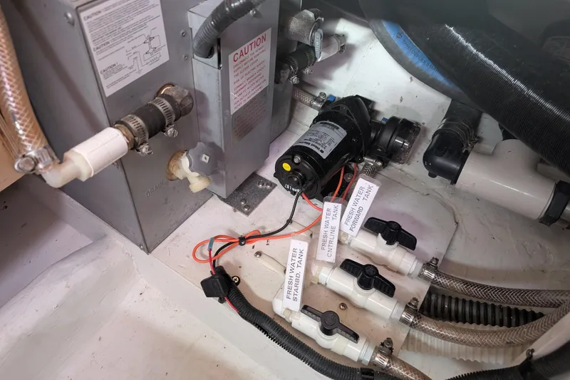 Slide: The Image of Engine compartment of a 2007 Catalina 36 MkII sailboat, showing plumbing and electrical components. - 41