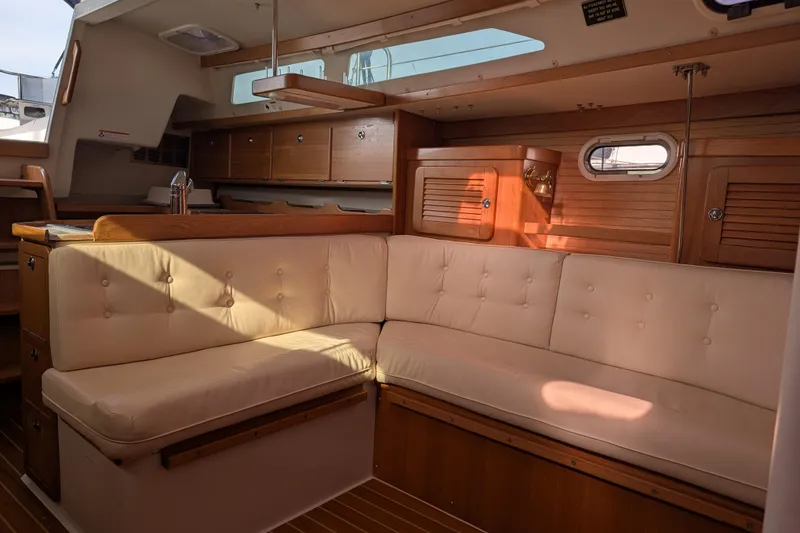 Slide: The Image of Interior of 2007 Catalina 36 MkII sailboat with beige cushioned seating and wooden cabinetry. - 16
