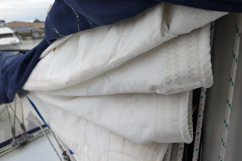 Slide: The Image of Folded sail on a 2007 Catalina 36 MkII sailboat, with visible stitching and rigging. - 47