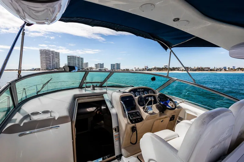 Slide: The Image of 2005 Sea Ray 340 Sundancer yacht interior with ocean view and city skyline. - 10