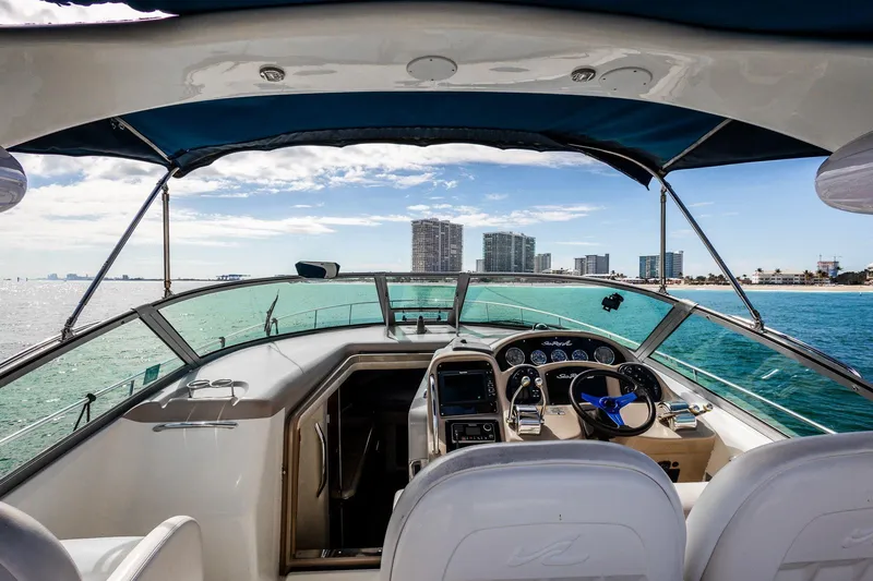 Slide: The Image of 2005 Sea Ray 340 Sundancer yacht cockpit with ocean and city skyline view. - 11
