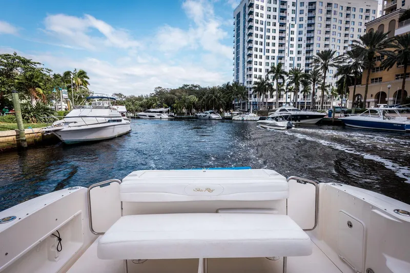 Slide: The Image of 2005 Sea Ray 340 Sundancer on a scenic waterfront with boats and palm trees. - 15