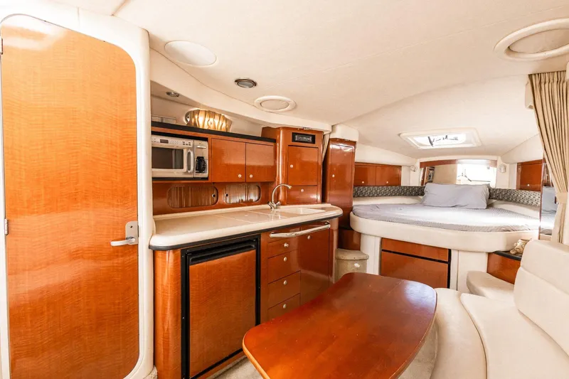 Slide: The Image of Luxurious 2005 Sea Ray 340 Sundancer cabin interior with kitchenette and cozy sleeping area. - 17