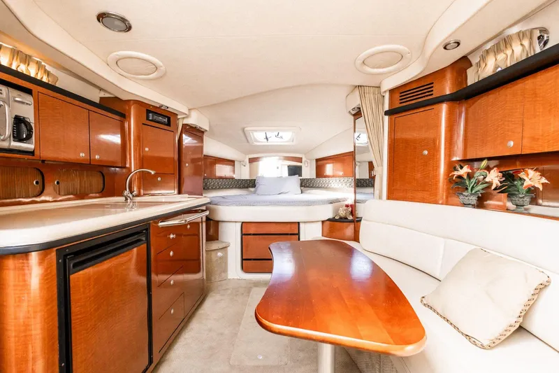 Slide: The Image of Luxurious interior of 2005 Sea Ray 340 Sundancer yacht with wood cabinetry and cozy seating. - 20