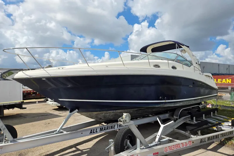 Slide: The Image of 2005 Sea Ray 340 Sundancer boat on trailer under cloudy sky. - 22