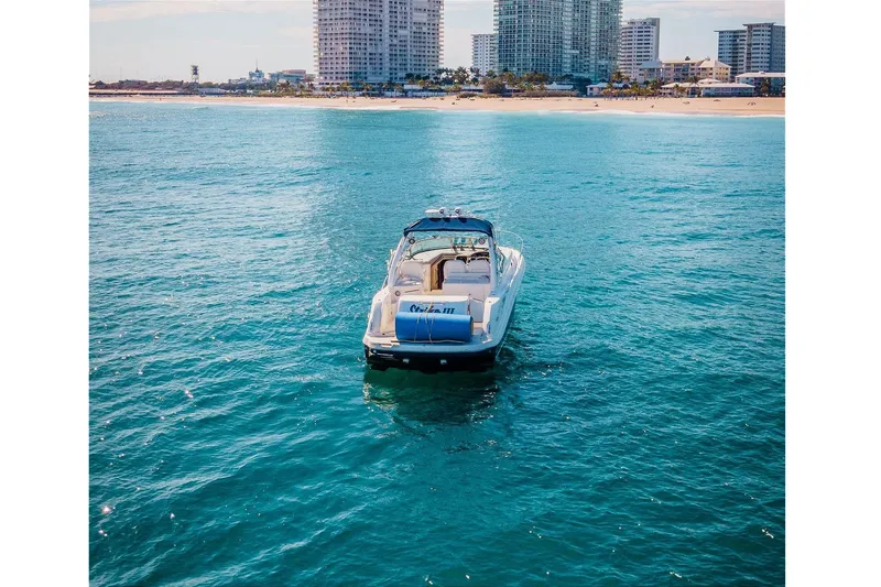 Slide: The Image of 2005 Sea Ray 340 Sundancer yacht on blue ocean near city skyline. - 3