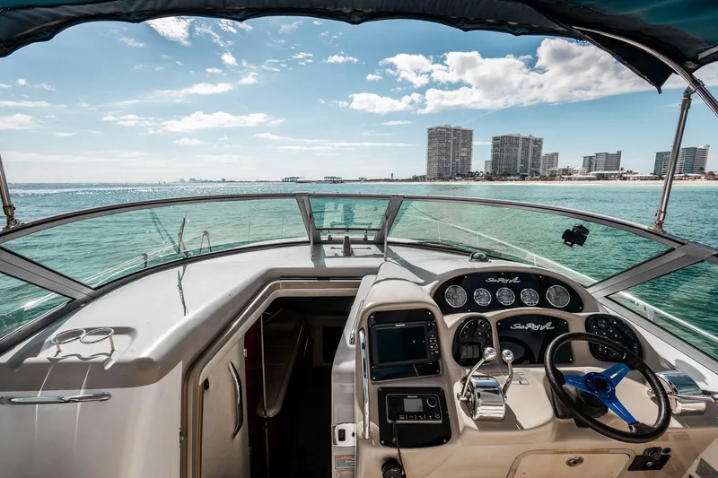 Slide: The Image of 2005 Sea Ray 340 Sundancer helm with ocean view and city skyline in the background. - 6