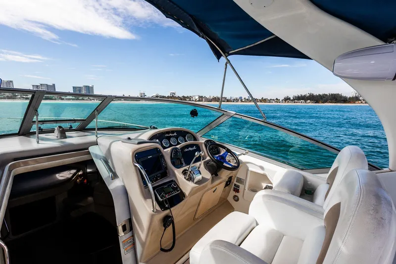 Slide: The Image of 2005 Sea Ray 340 Sundancer cockpit with ocean view and modern controls. - 9
