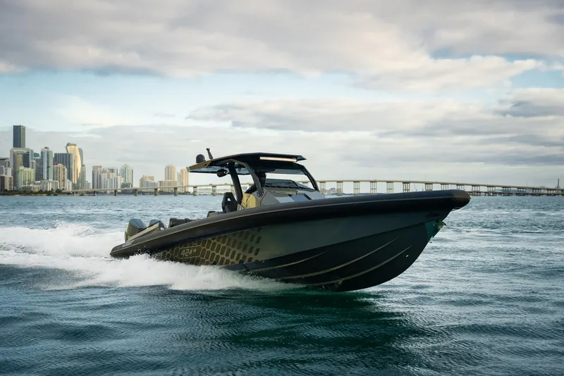 The Image of 2024 Skipper-BSK 42 boat cruising on water with city skyline in background. - 0
