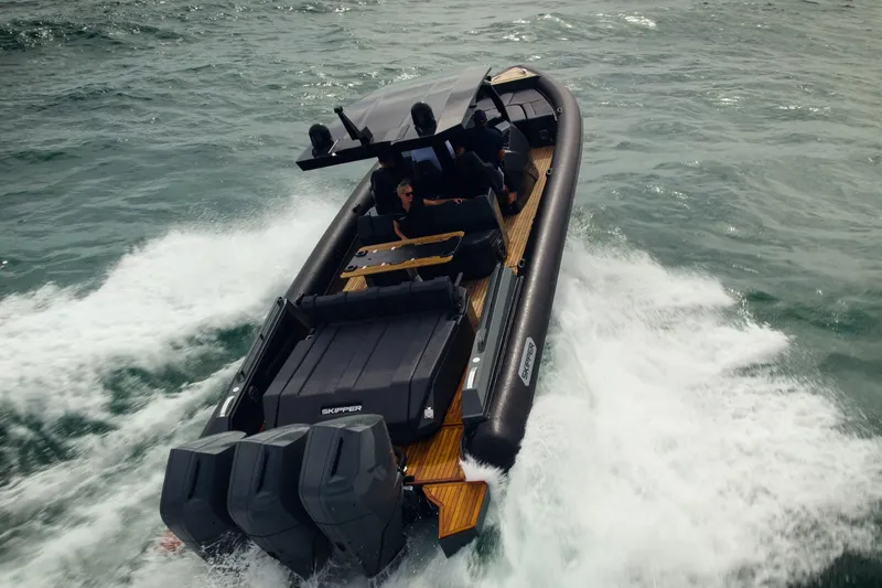 Slide: The Image of 2024 Skipper-BSK 42 boat cruising near a lighthouse and beach. - 2