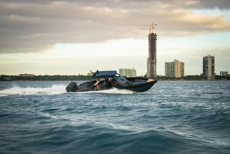 Slide: The Image of 2024 Skipper-BSK 42 boat cruising on open water with scenic background. - 4