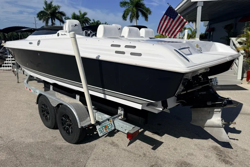 Slide: The Image of 2007 Donzi 27 ZR speedboat on trailer, black and white design, parked outdoors. - 11