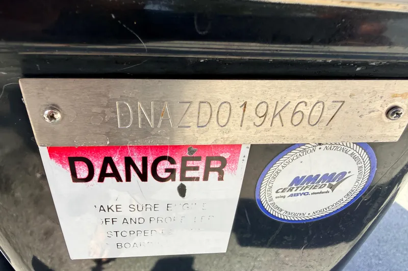 Slide: The Image of 2007 Donzi 27 ZR speedboat with sleek white interior and modern dashboard. - 14