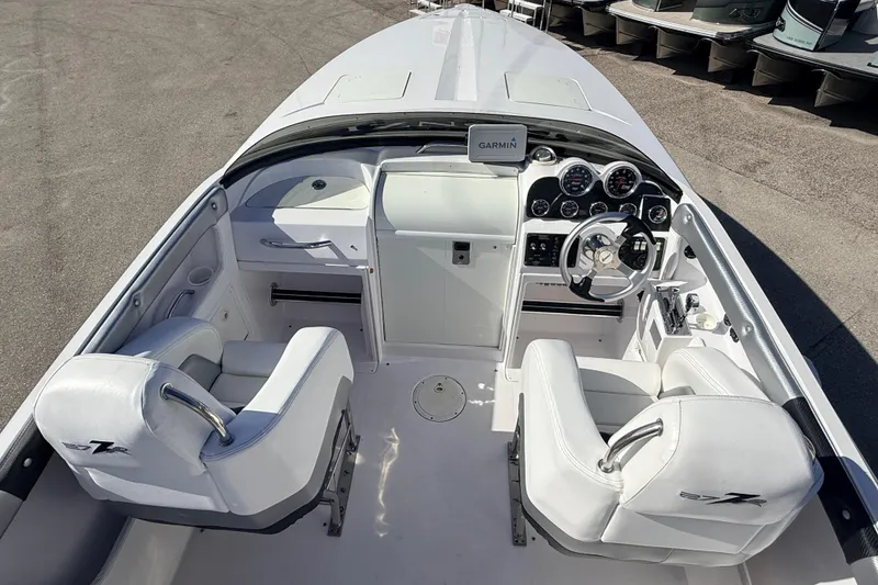 Slide: The Image of 2007 Donzi 27 ZR boat cockpit with steering wheel and gauges. - 17