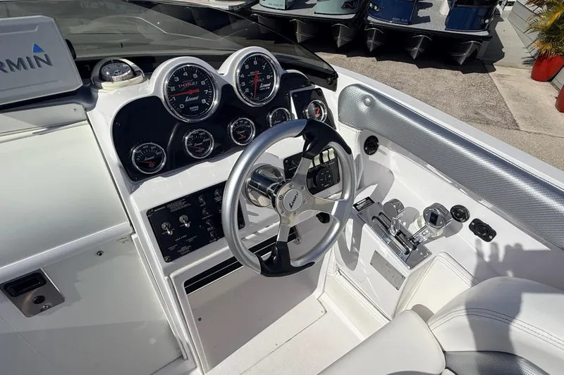 Slide: The Image of 2007 Donzi 27 ZR boat dashboard with Garmin GPS and multiple gauges. - 19