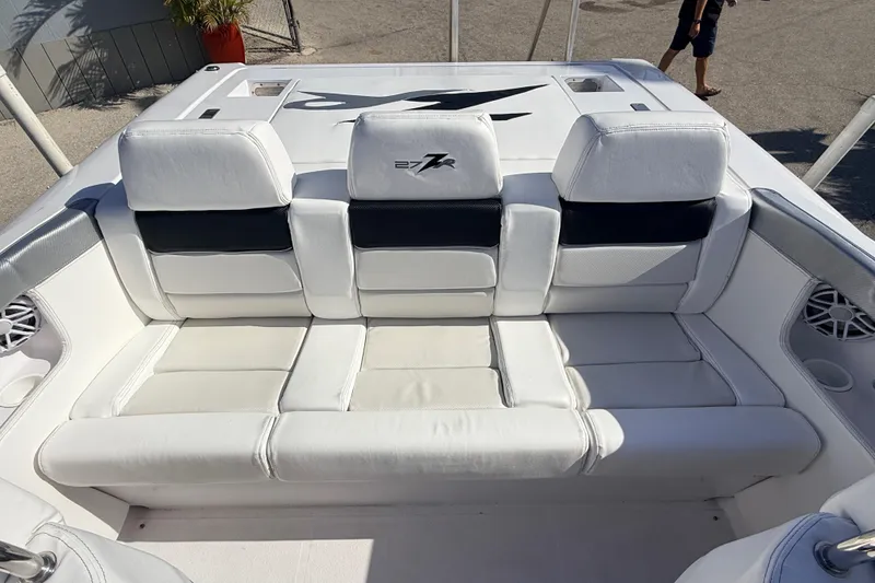 Slide: The Image of Interior of a 2007 Donzi 27 ZR boat, featuring white seating and speaker. - 23