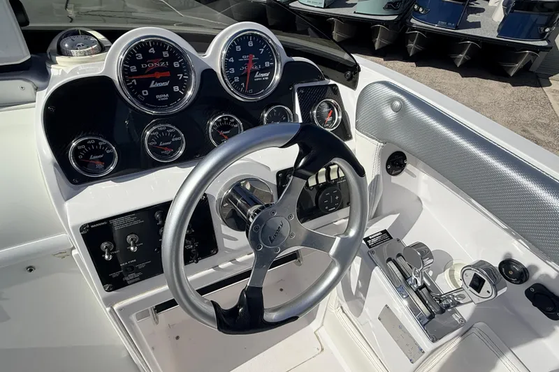 Slide: The Image of Interior cabin of a 2007 Donzi 27 ZR boat with beige seating and dark flooring. - 27