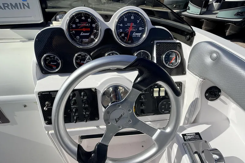 Slide: The Image of Interior cabin of a 2007 Donzi 27 ZR boat with white seating and carpeted floor. - 28