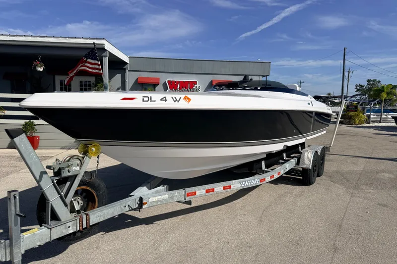 Slide: The Image of 2007 Donzi 27 ZR boat on trailer, parked outdoors with American flag nearby. - 3