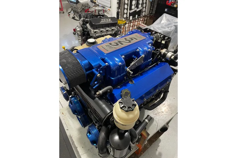 Slide: The Image of 2007 Donzi 27 ZR engine in workshop, featuring blue components and detailed mechanics. - 38