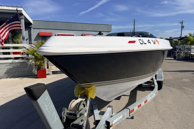 Slide: The Image of 2007 Donzi 27 ZR speedboat on trailer under clear blue sky. - 4