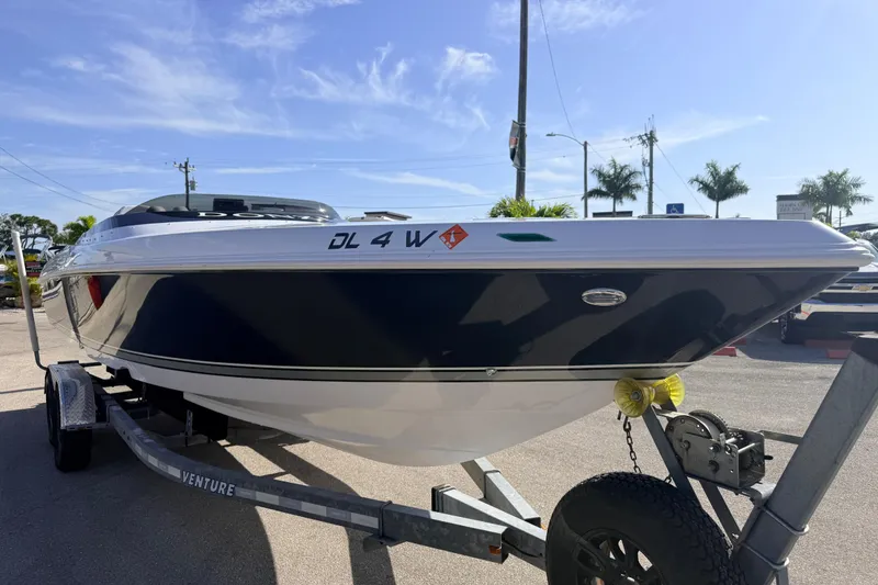 Slide: The Image of 2007 Donzi 27 ZR speedboat on trailer, parked outdoors under a clear sky. - 5