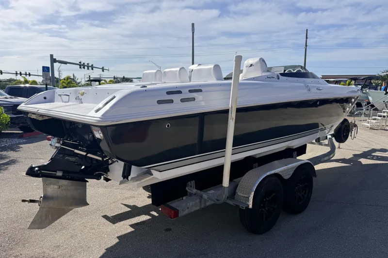 Slide: The Image of 2007 Donzi 27 ZR speedboat on trailer, parked outdoors under a clear sky. - 6