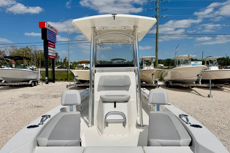 Slide: The Image of 2026 Bay Rider 219 Bay boat displayed at a dealership under a clear blue sky. - 10