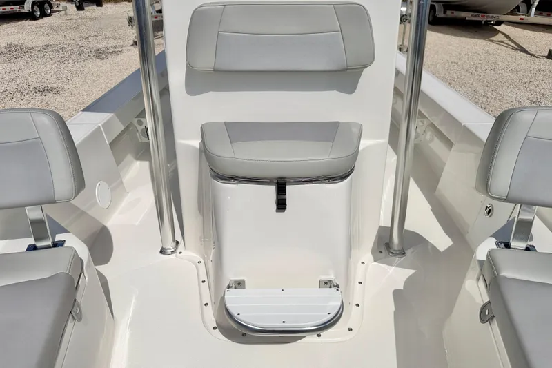 Slide: The Image of 2026 Bay Rider 219 Bay boat interior with cushioned seating and storage compartment. - 11