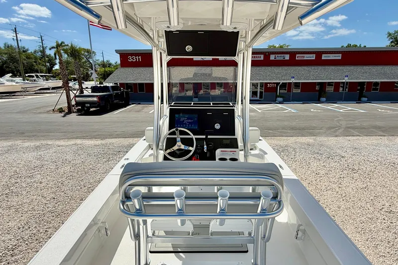 Slide: The Image of 2026 Bay Rider 219 Bay boat interior with steering console, parked at dealership. - 13