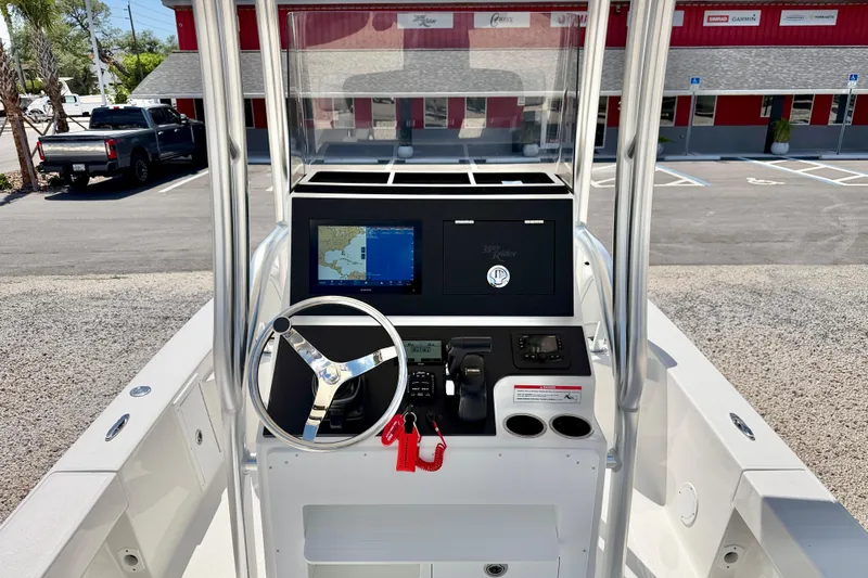 Slide: The Image of 2026 Bay Rider 219 Bay boat console with steering wheel and navigation display. - 14