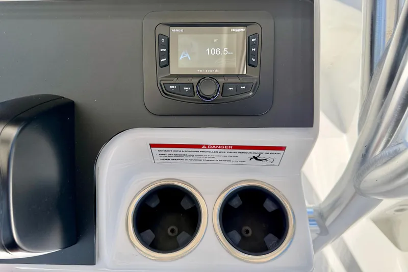Slide: The Image of 2026 Bay Rider 219 Bay boat console with radio and dual cup holders. - 17