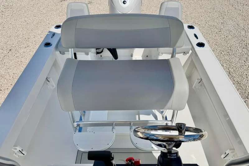 Slide: The Image of 2026 Bay Rider 219 Bay boat interior with dual seating and steering wheel. - 23