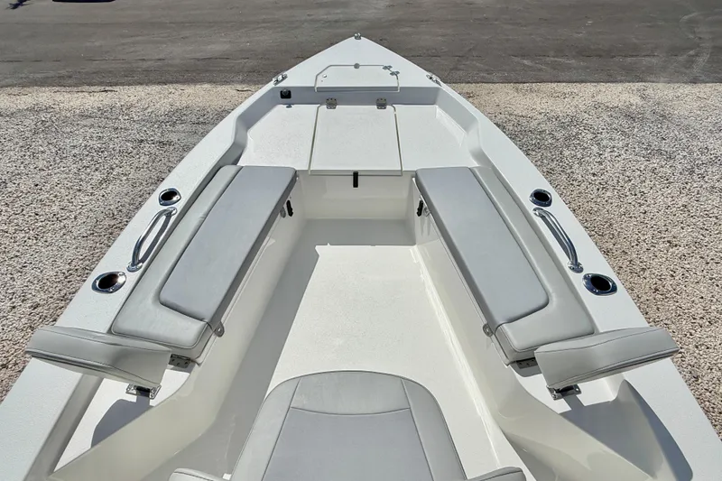 Slide: The Image of 2026 Bay Rider 219 Bay boat interior with cushioned seating and storage compartments. - 25