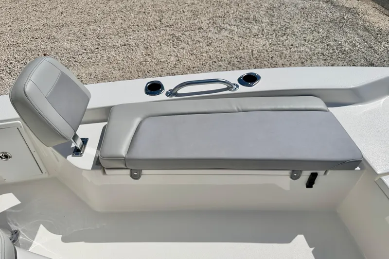 Slide: The Image of 2026 Bay Rider 219 Bay boat seating area with gray cushioned bench and backrest. - 27