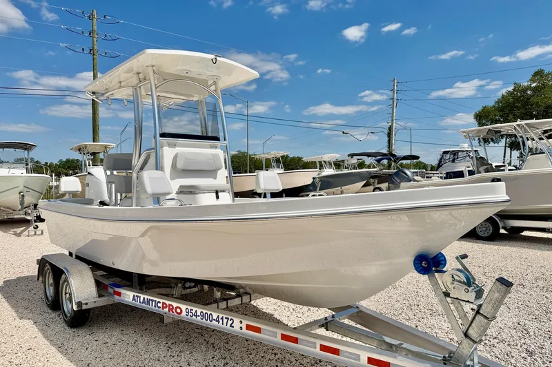 Slide: The Image of 2026 Bay Rider 219 Bay boat on trailer under clear blue sky. - 3